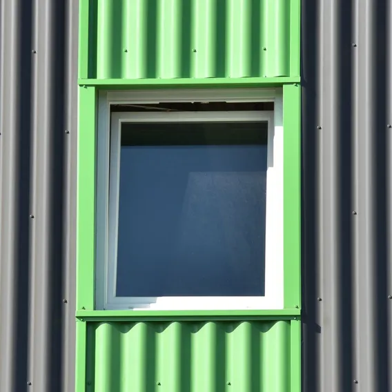 Green painted window on grey cladding