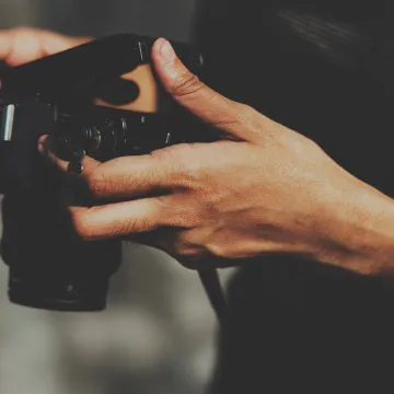 Closeup of hands checking film in camera