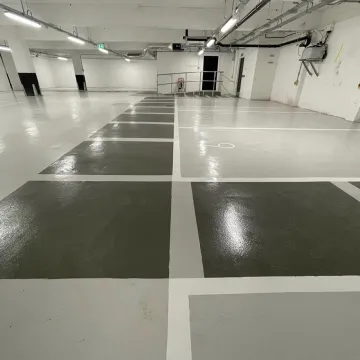 Glossy underground parking lot with marked spaces