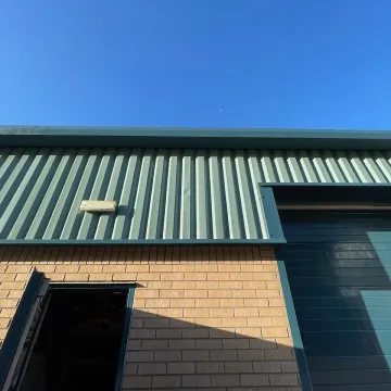 Close-up of green-roofed warehouse building