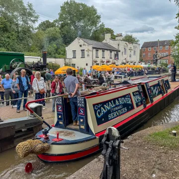 A narrowboat passes through a lock at Audlem Wharf
