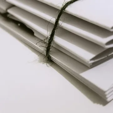 Pile of white envelopes tied with a green string