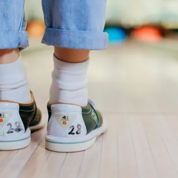 Close-up shot of a person wearing bowling shoes