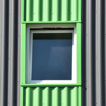 Green painted window on grey cladding