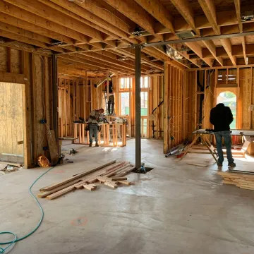 Workers constructing a house framework