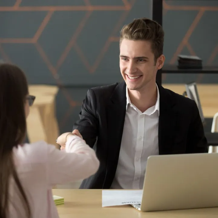 Smiling hr employer handshaking successful job applicant hir