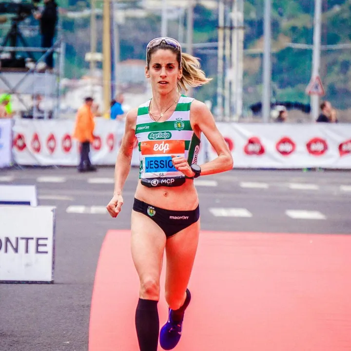 Focused female athlete crossing the finish line