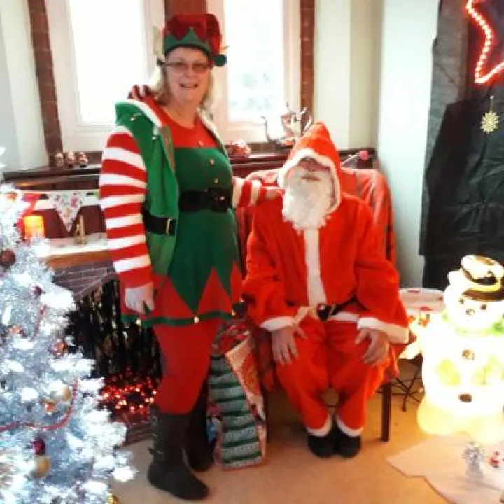 Father Christmas with helper in his grotto