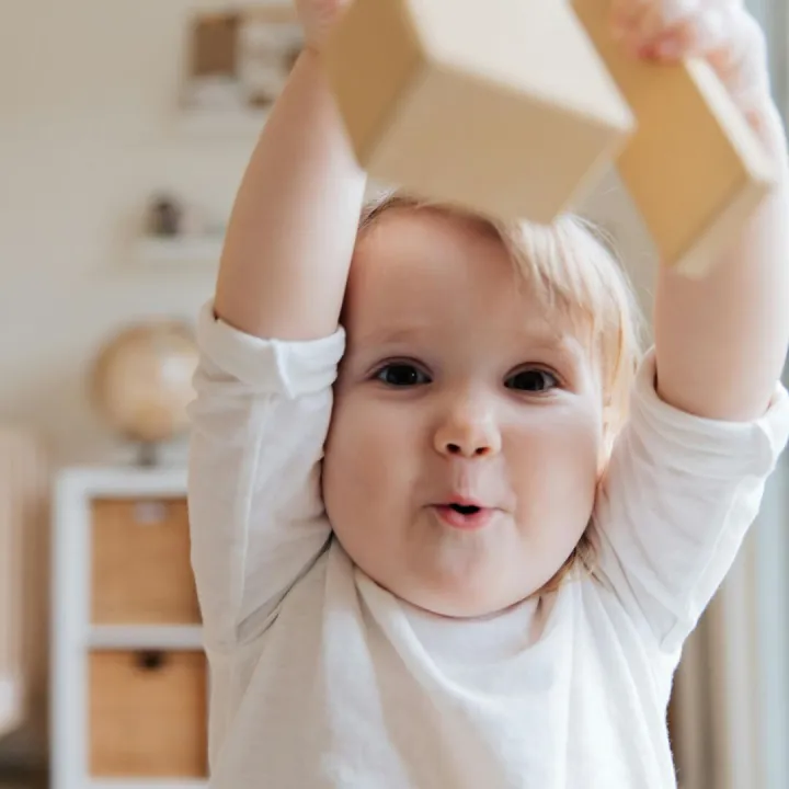 Adorable baby enjoying playtime with wooden