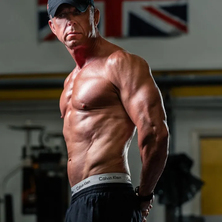 Personal Trainer Standing in Gym Environment