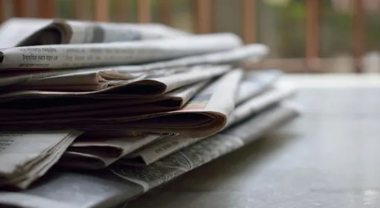 A close-up of a stack of newspapers resting on a