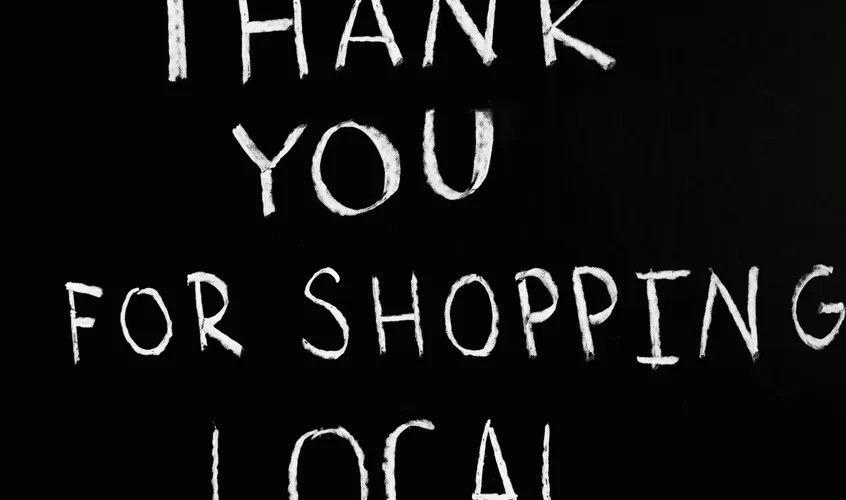 A handwritten chalkboard thanking customers for supporting a local business