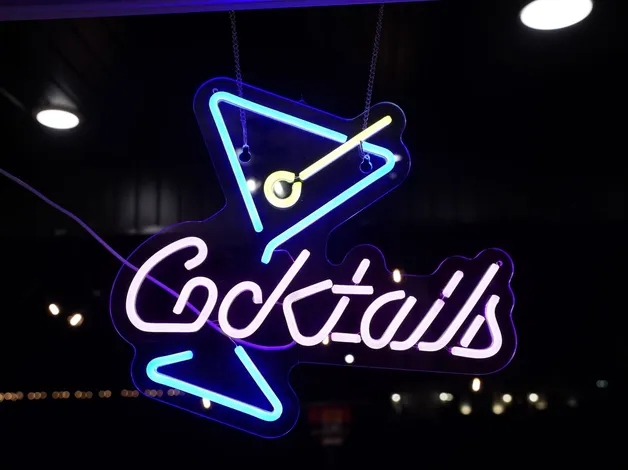 Neon cocktails sign above the bar