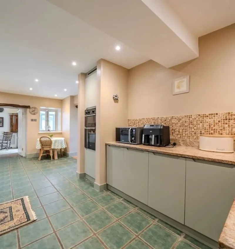 The modern farmhouse kitchen with sage green units