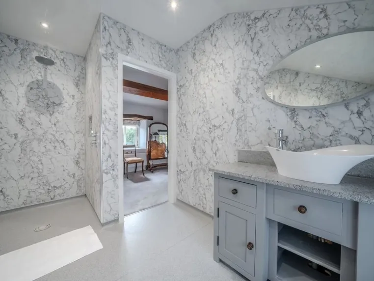 The marble en-suite wet room to bedroom one