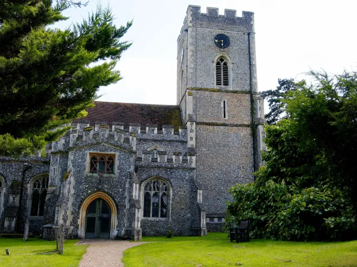 A church set among trees and greenery