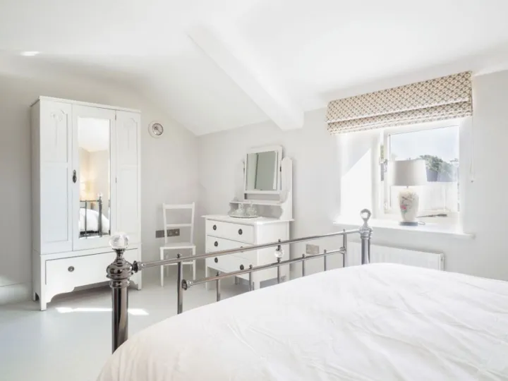 Bedroom one at Otters Retreat with a king size bed and countryside views
