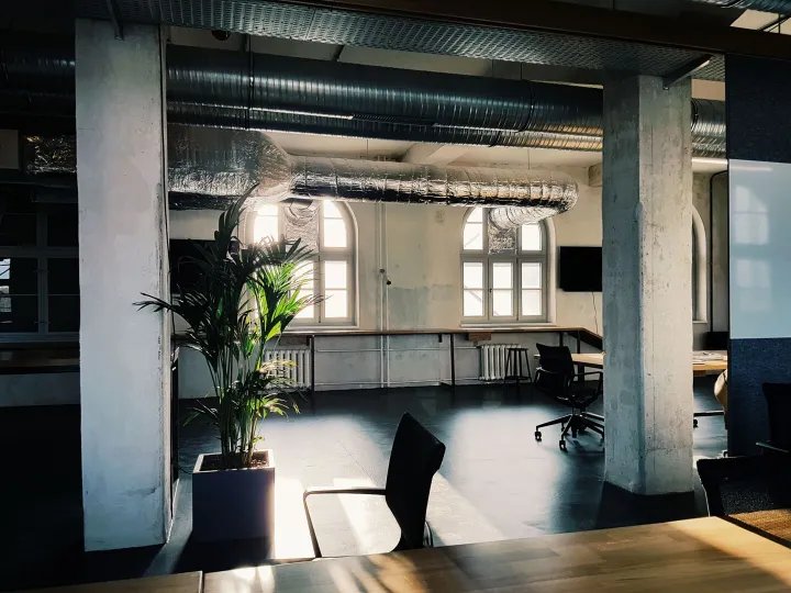 Modern workplace interior with exposed services and daylight