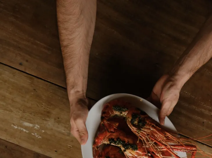 A plate of freshly cooked lake prawns carried to the table at Peacock Hill Sigiriya
