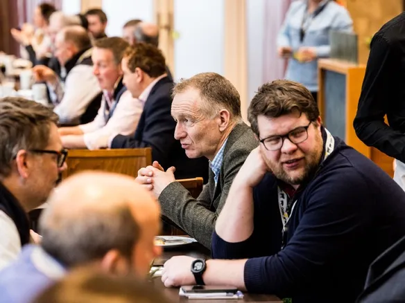 Delegates in discussion around a table