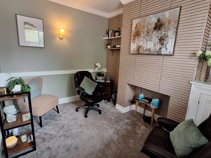 Wilmslow therapy room with armchairs, a desk chair and soft lighting