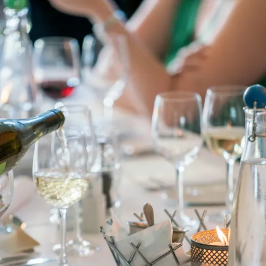 Person Pouring Wine on Clear Wine Glass