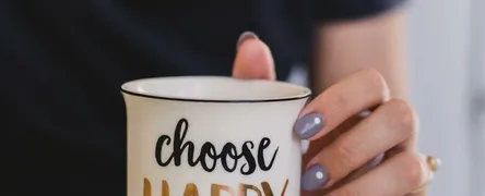 Selective Focus Photography of Person Touch the White Ceramic Mug With Choose Happy Graphic