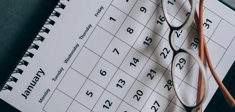 A close-up of a January calendar with eyeglasses