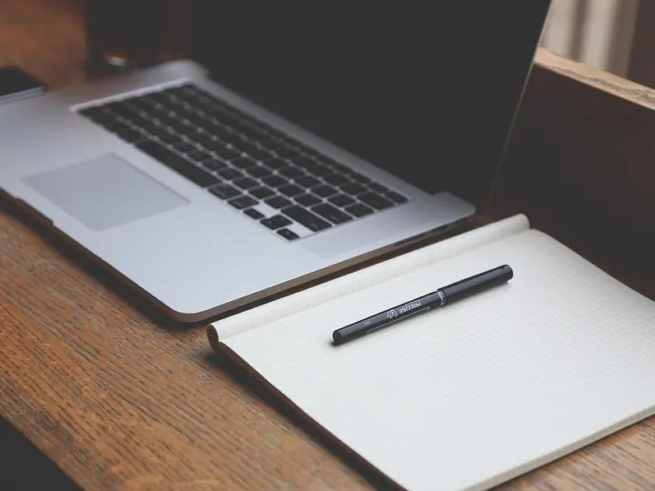 Laptop and notebook on a desk
