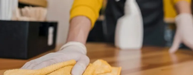 Front view of barista cleaning table