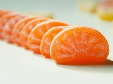 Close-up of vibrant orange candy pieces arranged