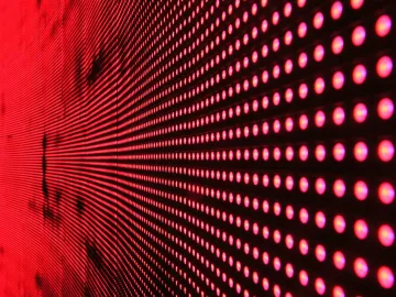 Vibrant abstract pattern of illuminated red LED lights forming a dynamic design.