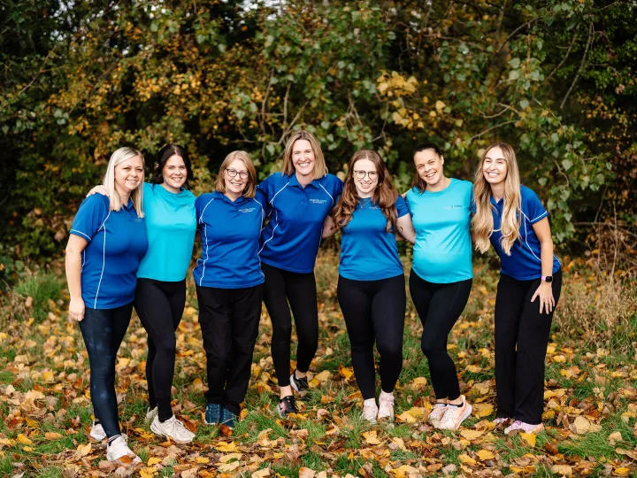 Team photo arms round each other