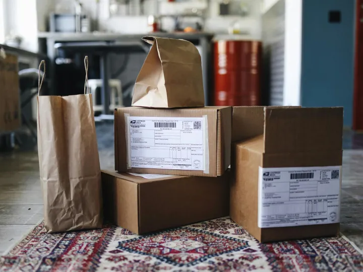 A collection of cardboard boxes and paper bags on 