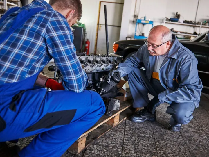 Mechanics repairing a car in the workshop