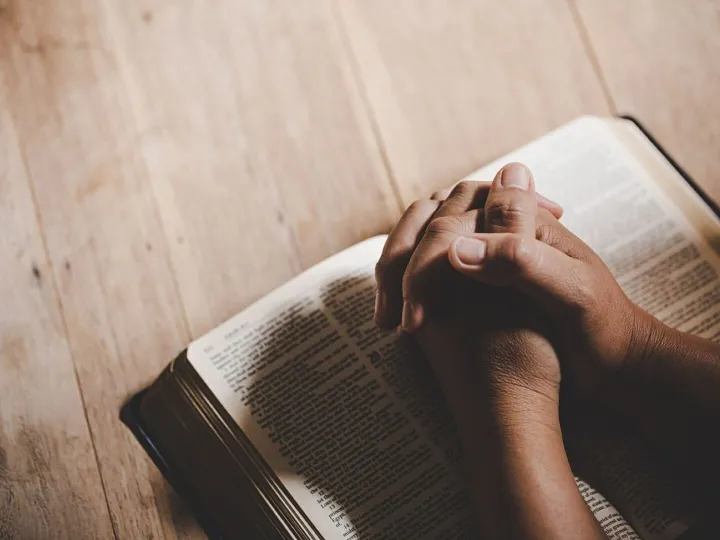 Spirituality and religion, Hands folded in prayer on a Holy 