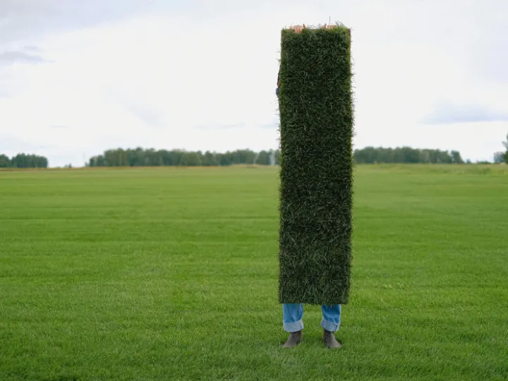 Unrecognizable farmer with grass lawn