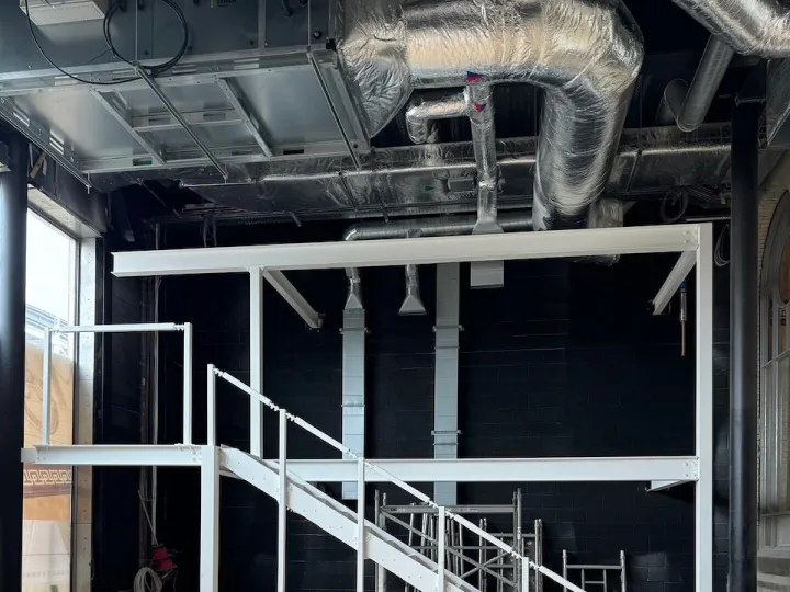 Warehouse construction featuring metal staircase and steel framework