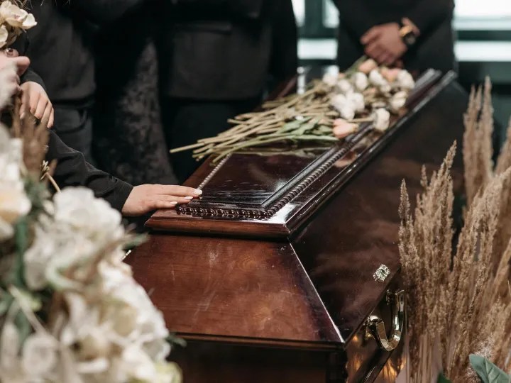 A poignant funeral moment with mourners gathered