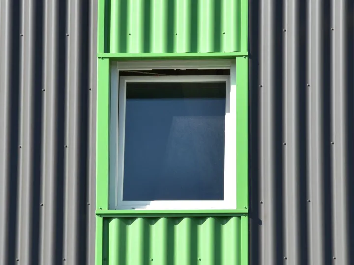 Green painted window on grey cladding
