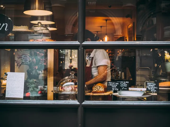 Warm bakery scene in London through window showcas