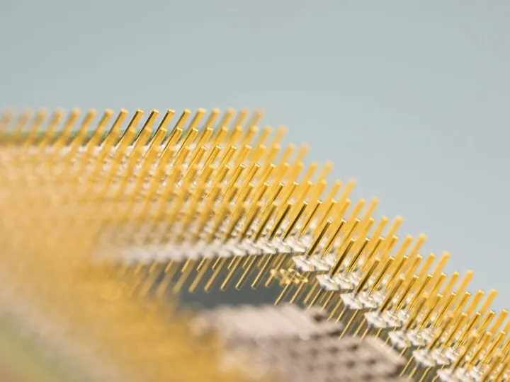 Detailed close-up of gold CPU pins, showcasing tec