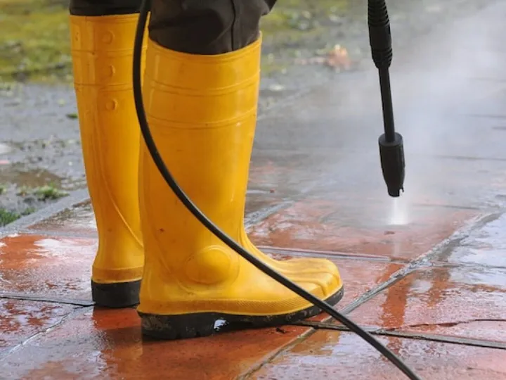Person wearing yellow rubber boots with