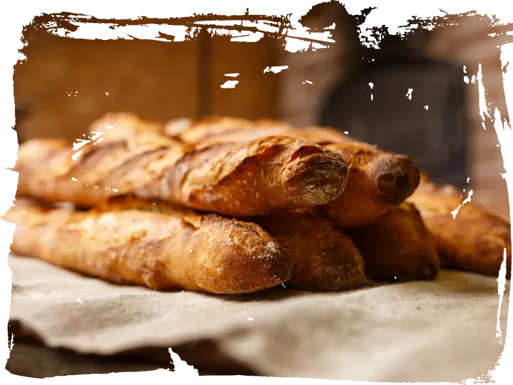Warm, freshly baked rustic baguettes stacked in a